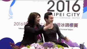 GIF of Patrick Chan and coach Kathy Johnson waving to fans holding up a banner, "The CHANpion is back", at the 2016 Four Continents Championships in Taipei, Taiwan.