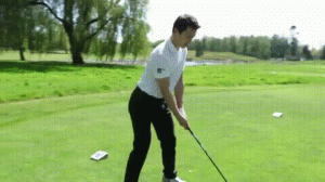 Patrick Chan practices his golf swing on the ASPAC green outdoors in sunny daylight, 2014. Source: YouTube